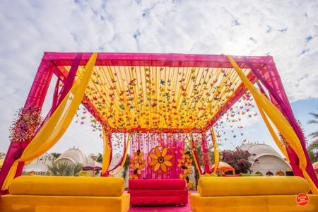 Photo of Pink and yellow mehendi decor theme with hangings