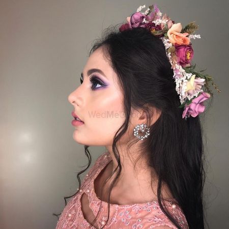 Photo of Subtle makeup with purple smoky eyeS and flowers in hair is the best combination.