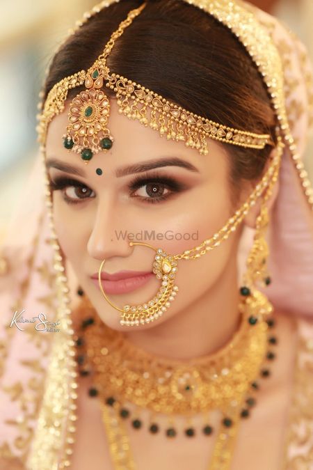 A beautiful bride on her wedding day in stunning gold jewellery. 