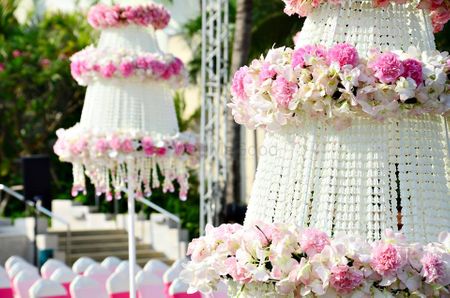Photo of White and light pink decorated parasols in decor