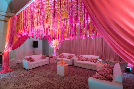 Tassel decor idea with orange and pink ceiling decor 