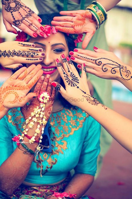 Bride with bridesmaids showing off jewellery mehendi