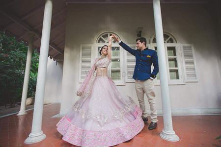 Photo of Couple Dancing with Twirling Bride Shot