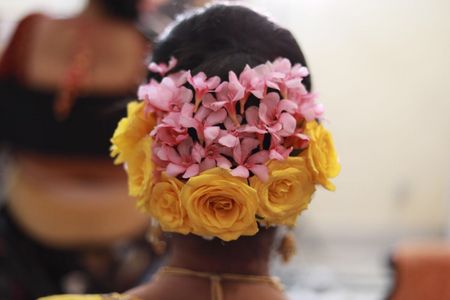 Yellow and pink bridal bun with big flowers