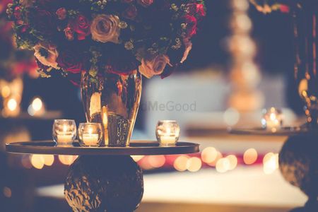 Photo of Floral Table Decor with Dim Glass Candles