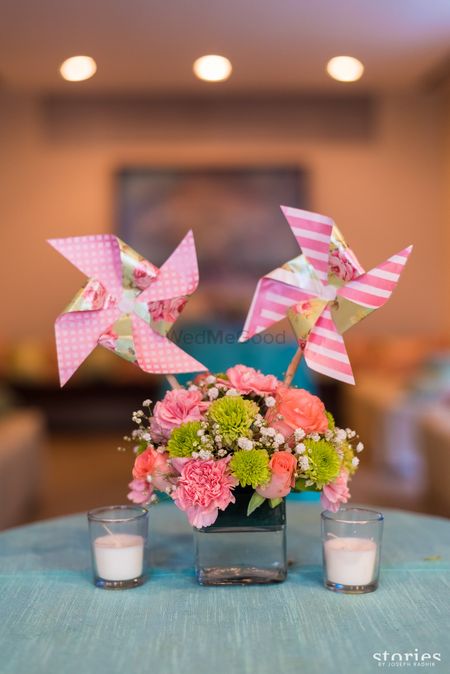 Pinwheels in centrepiece with floral arrangement
