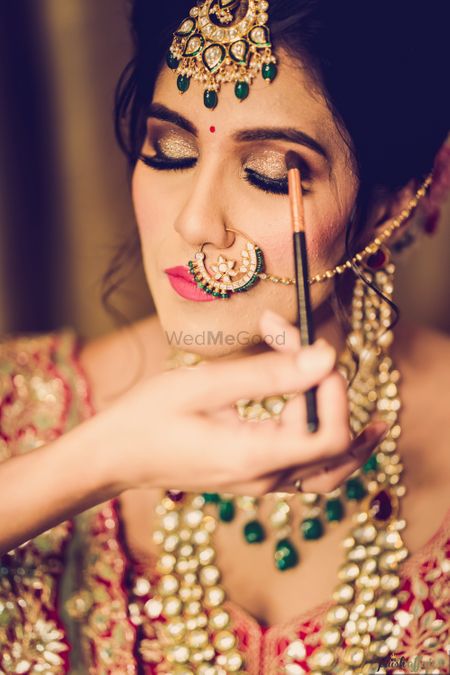 Photo of A bride getting her makeup done