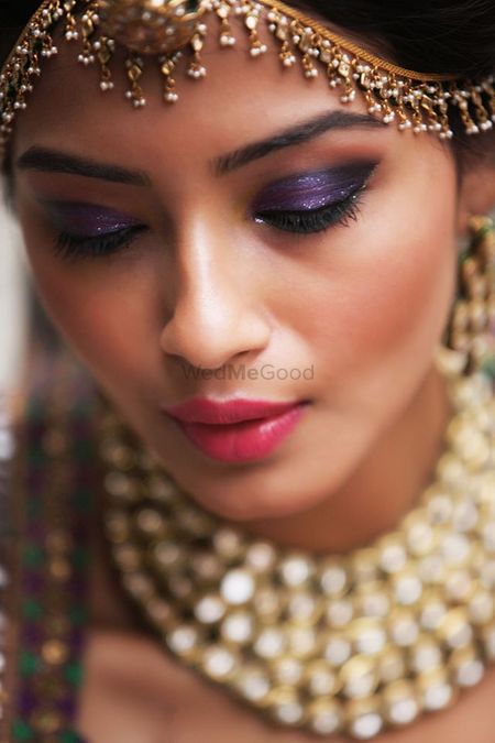 Photo of Gold Ghungroo Mathapatti and Purple Eye Makeup