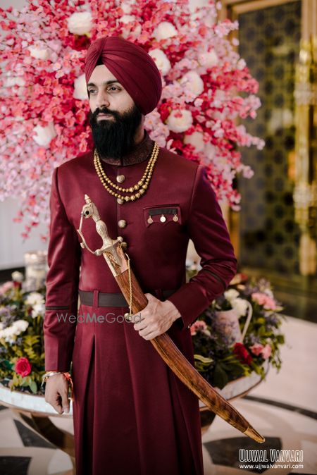 Photo of unique sherwani in maroon color