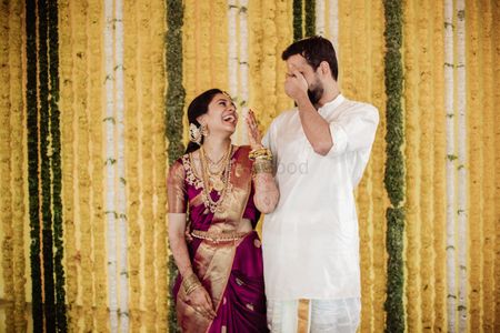 Photo of A shot of a couple laughing at their wedding function