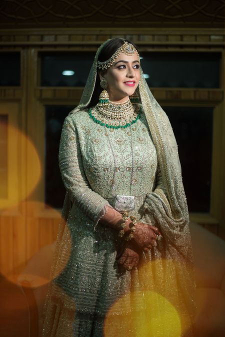 A bride in a shimmer lehenga with peplum top