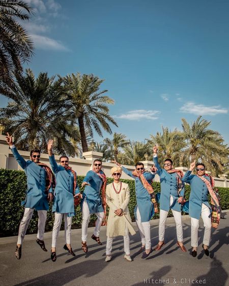 Photo of fun groom and groomsmen photo with all of them in blue sherwani