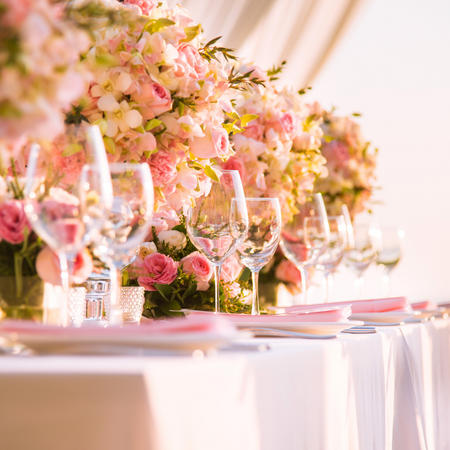 Photo of Table settings done with pastel hued flowers
