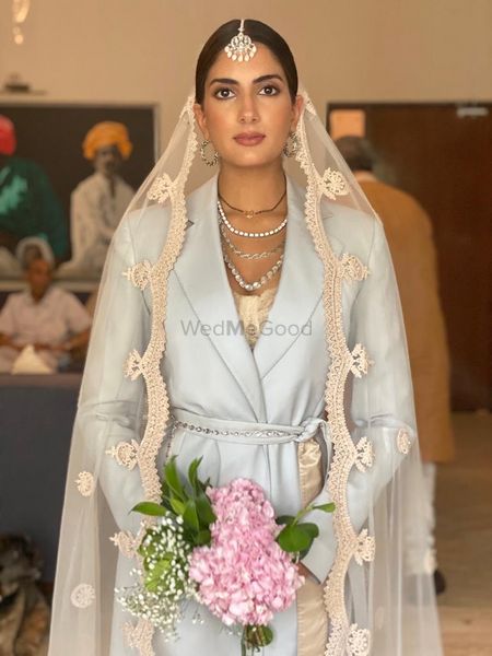 Photo of Millennial bride in a pantsuit with a dupatta as a veil