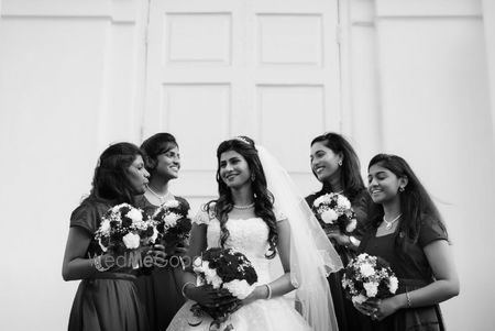 Photo of Monochrome shot of the bride with bridesmaids.