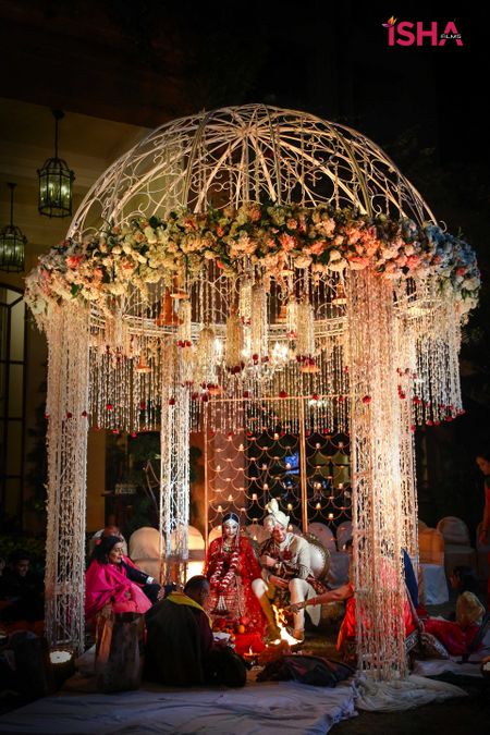 round mandap with hanging floral strings and iron structure