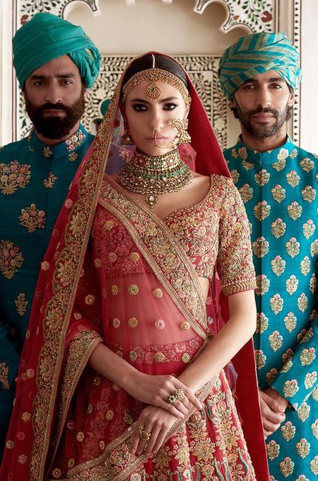 Photo of Wedding outfits for bride and groom by Sabyasachi