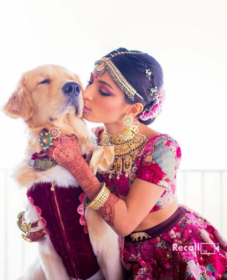 Photo of cute bridal shot with her kissing the dog