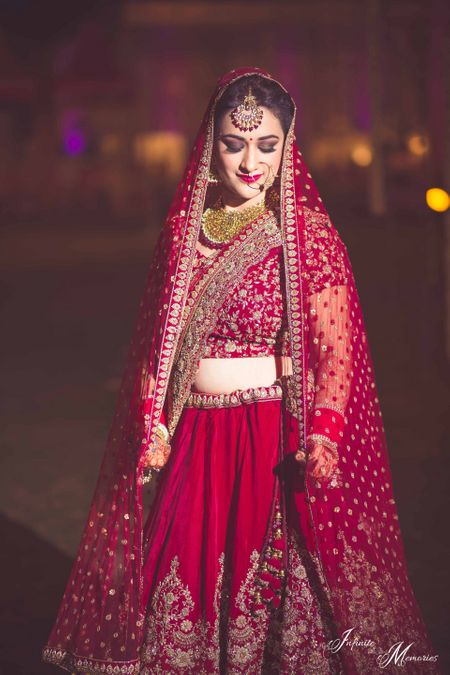 Photo of Deep red bridal lehenga with double dupatta draping style