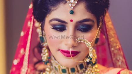 Photo of Dramatic smokey eye bridal makeup with loose bun 