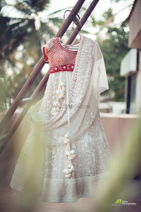 Photo of Offbeat bridal lehenga in white with contrasting red blouse