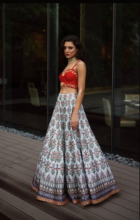 A red bustier blouse paired with a white printed skirt