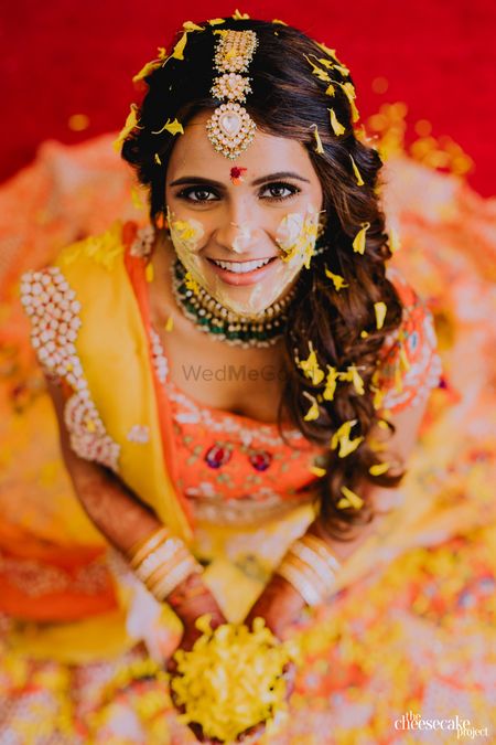 Indian bride sitting on stage and looking at camera during haldi ceremony  Stock Photo - Alamy