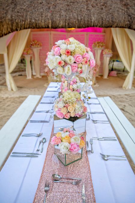Table Setting done with colorful floral vases and shimmery table runners