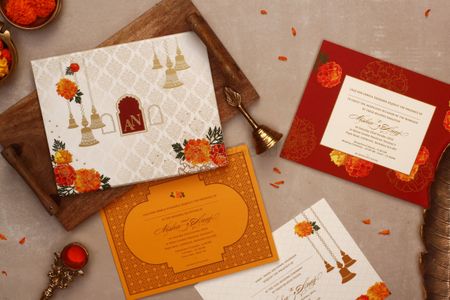 Photo of Wedding card with temple bell and marigold design