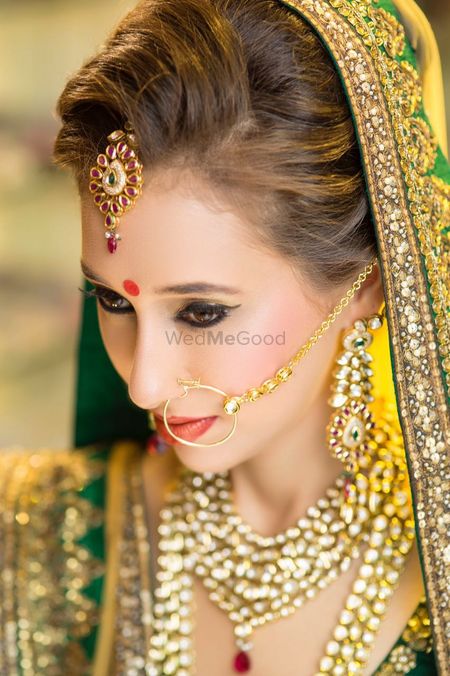 Photo of Subtle Bridal Makeup with Kitten Flick and Brown Lips