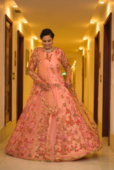 Light pink net gown with floral motifs 