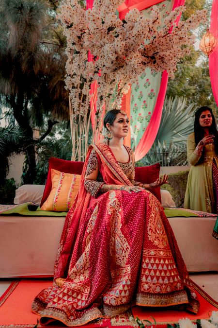 Photo of A bride in a red lehenga for her mehndi