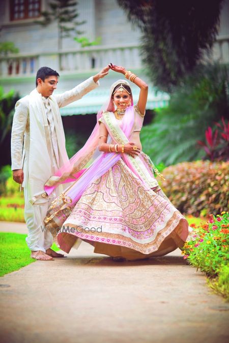 Photo of Bride Twirling in Day Wedding Light Pink Lehenga