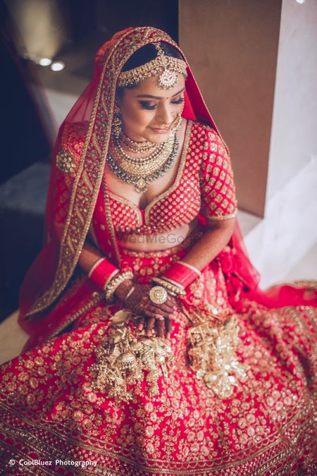 Photo of Bride in red and gold lehenga