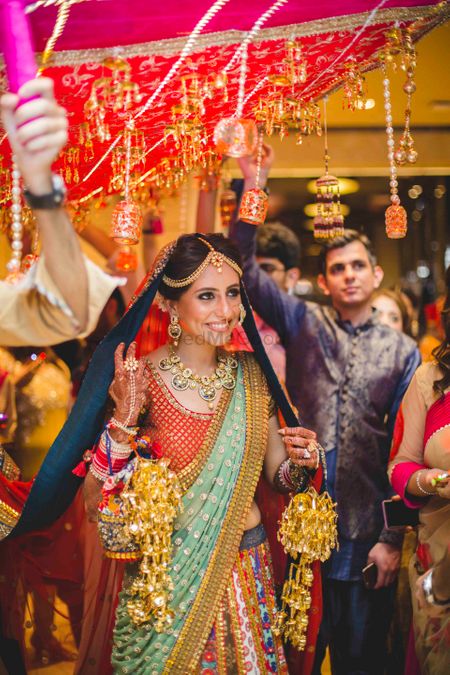 Photo of Happy Bride in Multicolour Lehenga Entering Wedding