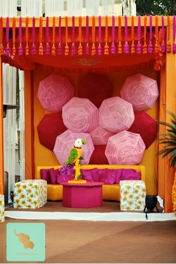 funky mehendi stage backdrop with umbrellas