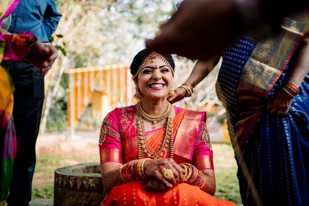 A candid shot of a happy south indian bride.