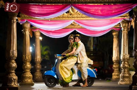 South indian wedding couple on vespa
