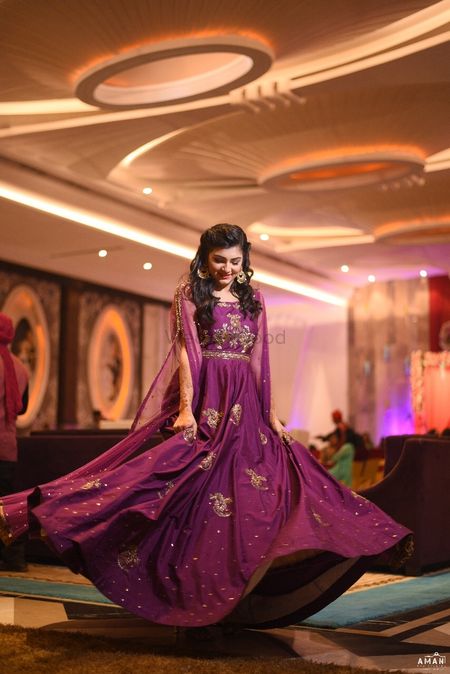 Photo of Twirling bride in wine coloured gown