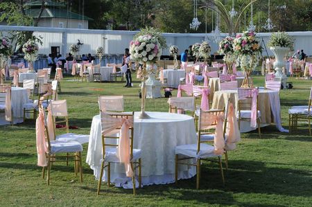 Photo of Pink and White Table Settings with Floral Centerpieces
