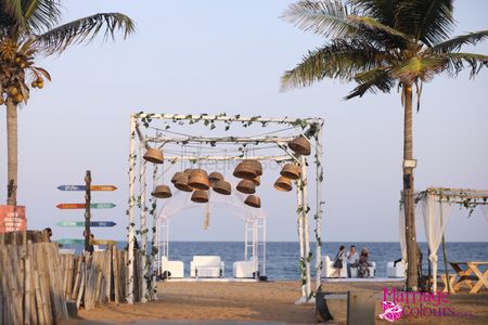 mandap with hanging cane baskets for beach wedding