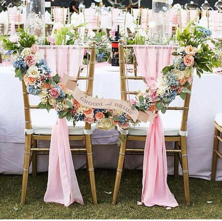 Photo of Unique floral bride and groom chairs