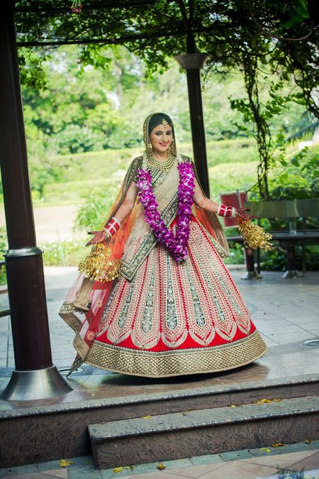 Flared red bridal lehenga with green patch work