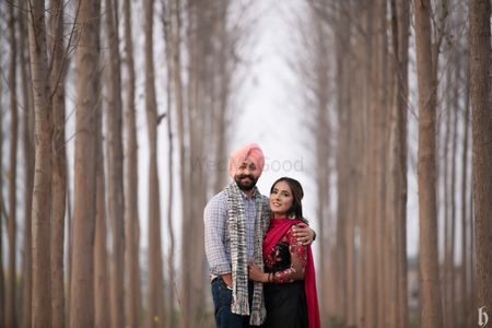 half body wide angle professional portrait photo of a beautiful Punjabi  couple