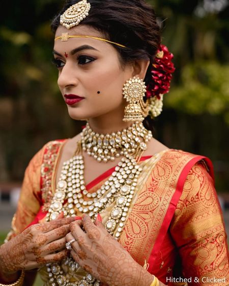 Photo of unique south indian bridal jewellery with polki and pretty earrings