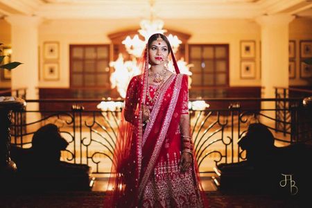 Photo of timeless bride in a red lehenga