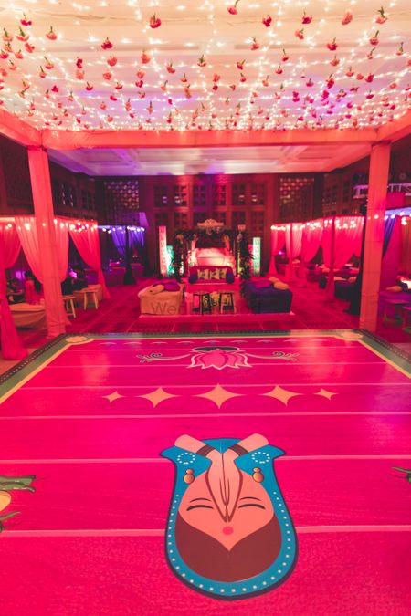 Bright pink dance floor with flowers and lights above