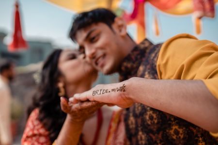 bride with her brother who has mehendi put