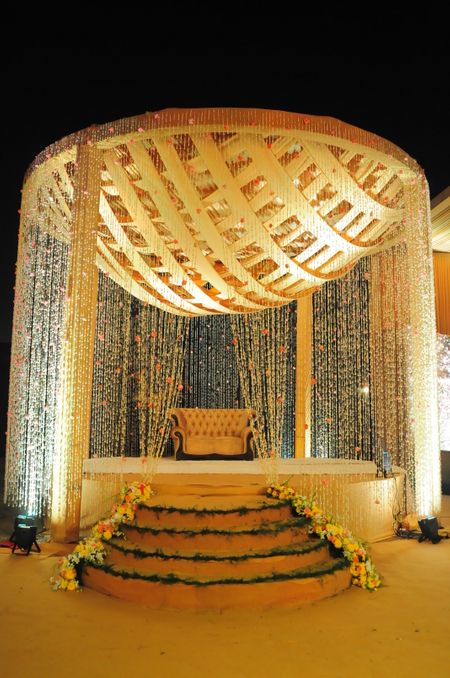 A dome-shaped mandap decorated with floral strings.