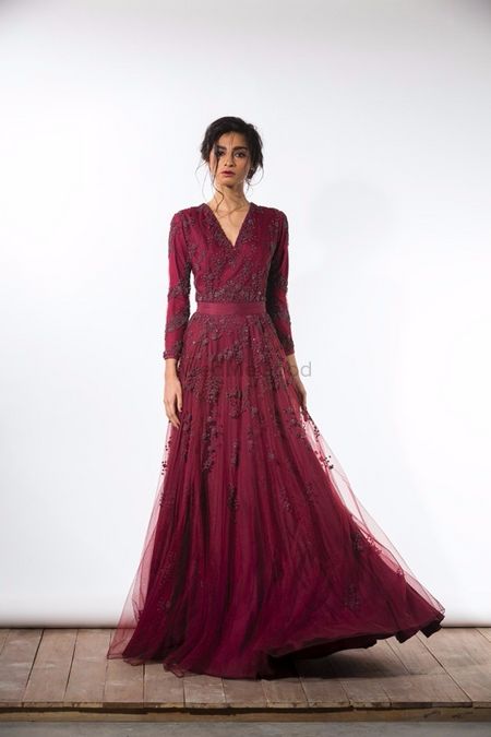 Wine coloured full sleeved gown with bead work and net